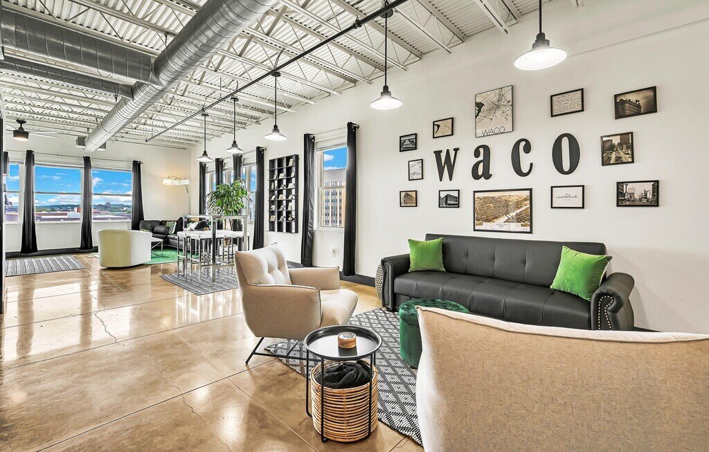 Open concept living and dining space in this one-bedroom, one-bathroom vacation rental condo with sleeping space for four is walking distance from the Silos, McLane Stadium, and Baylor University in downtown Waco, TX