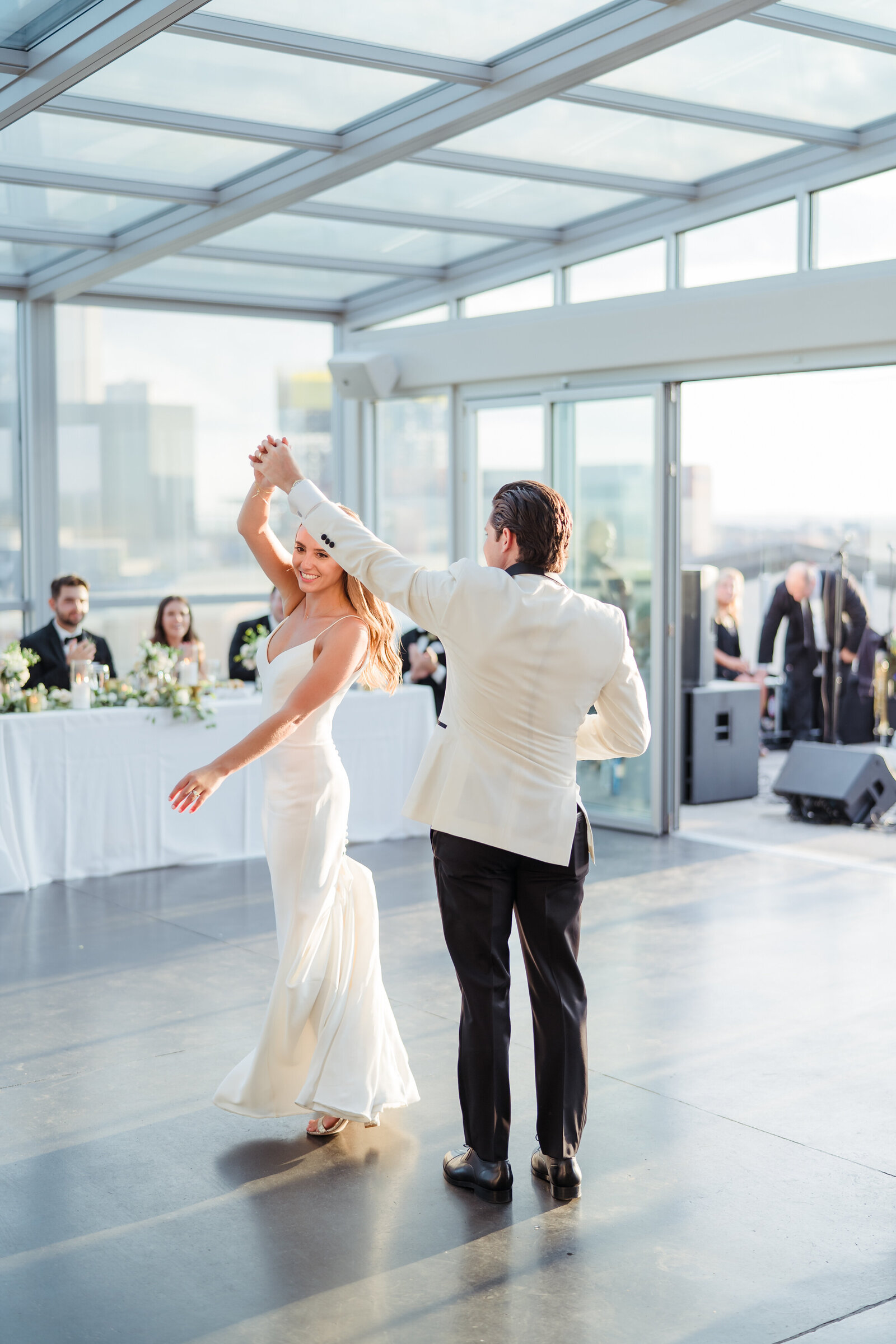 Bride and groom share a first dance in golden hour sunlight inside Revery