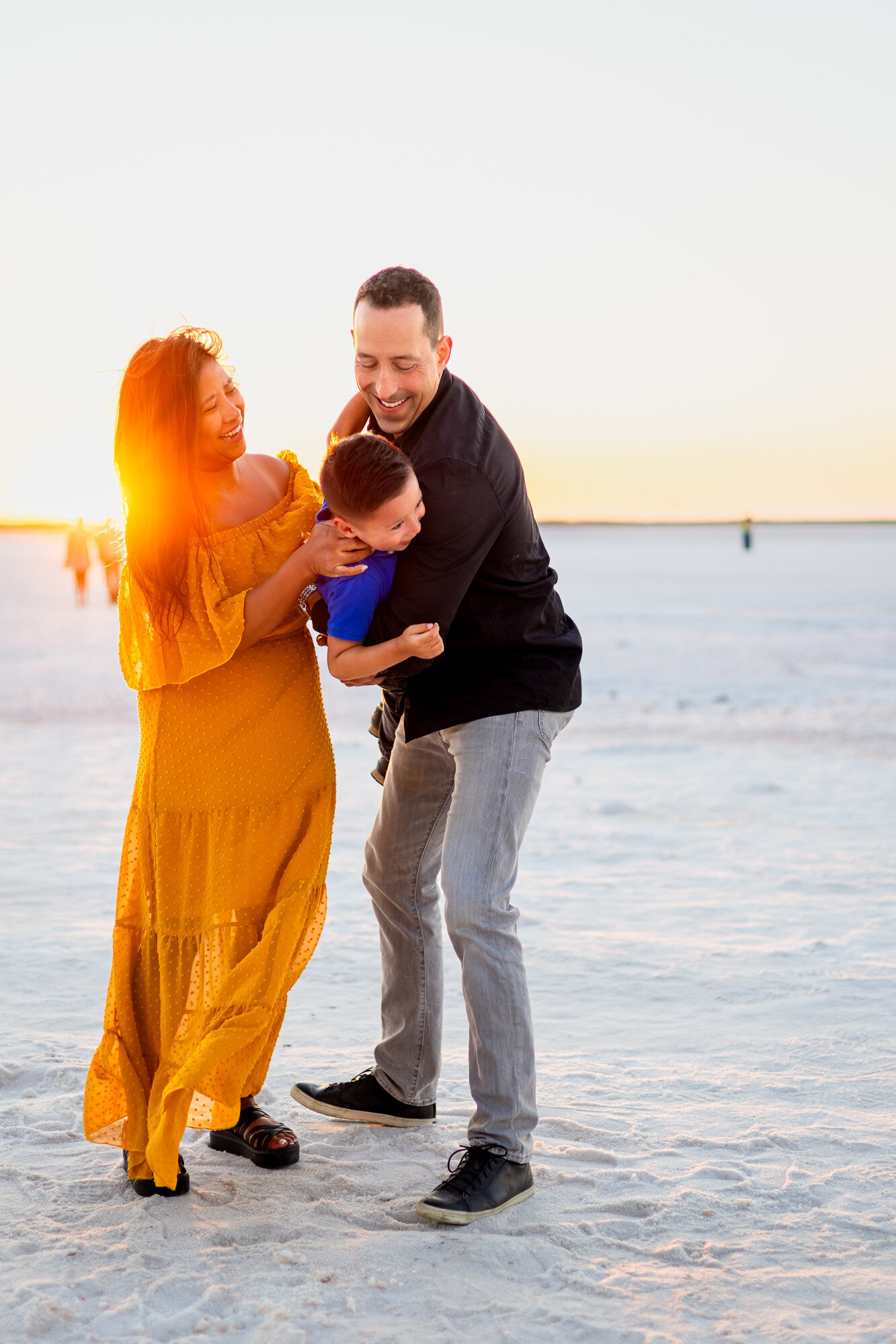 Parents and child smiling and playing in salt pond at sunset – Bay Area Family Portfolio - Ellobelle Photography
