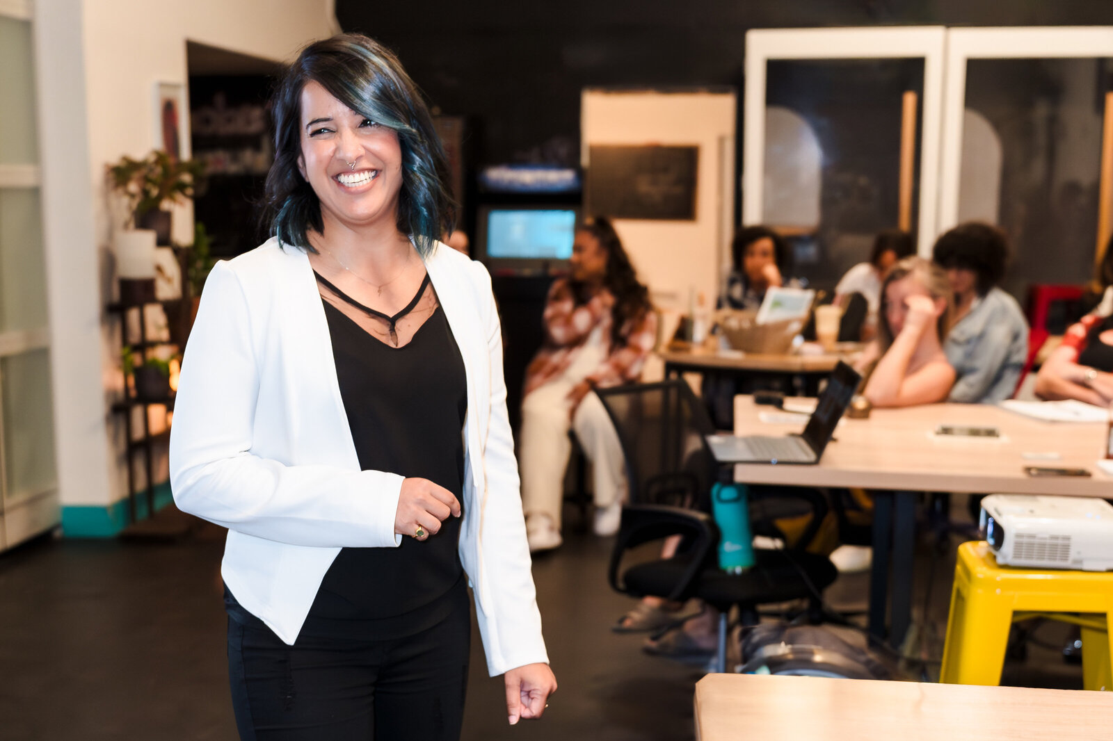 public speak smiles in a room full of women
