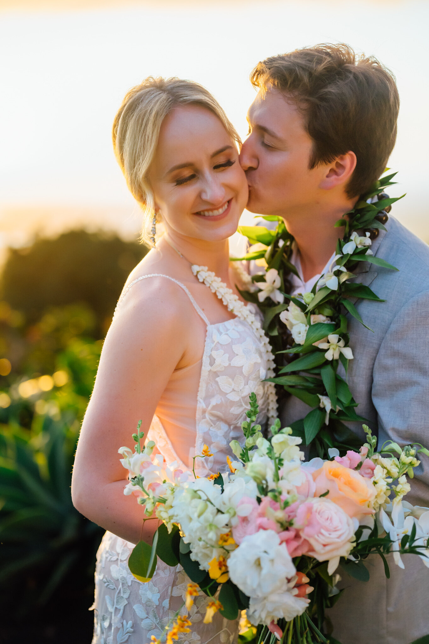 sunset glow while bride and groom kiss on their wedding day