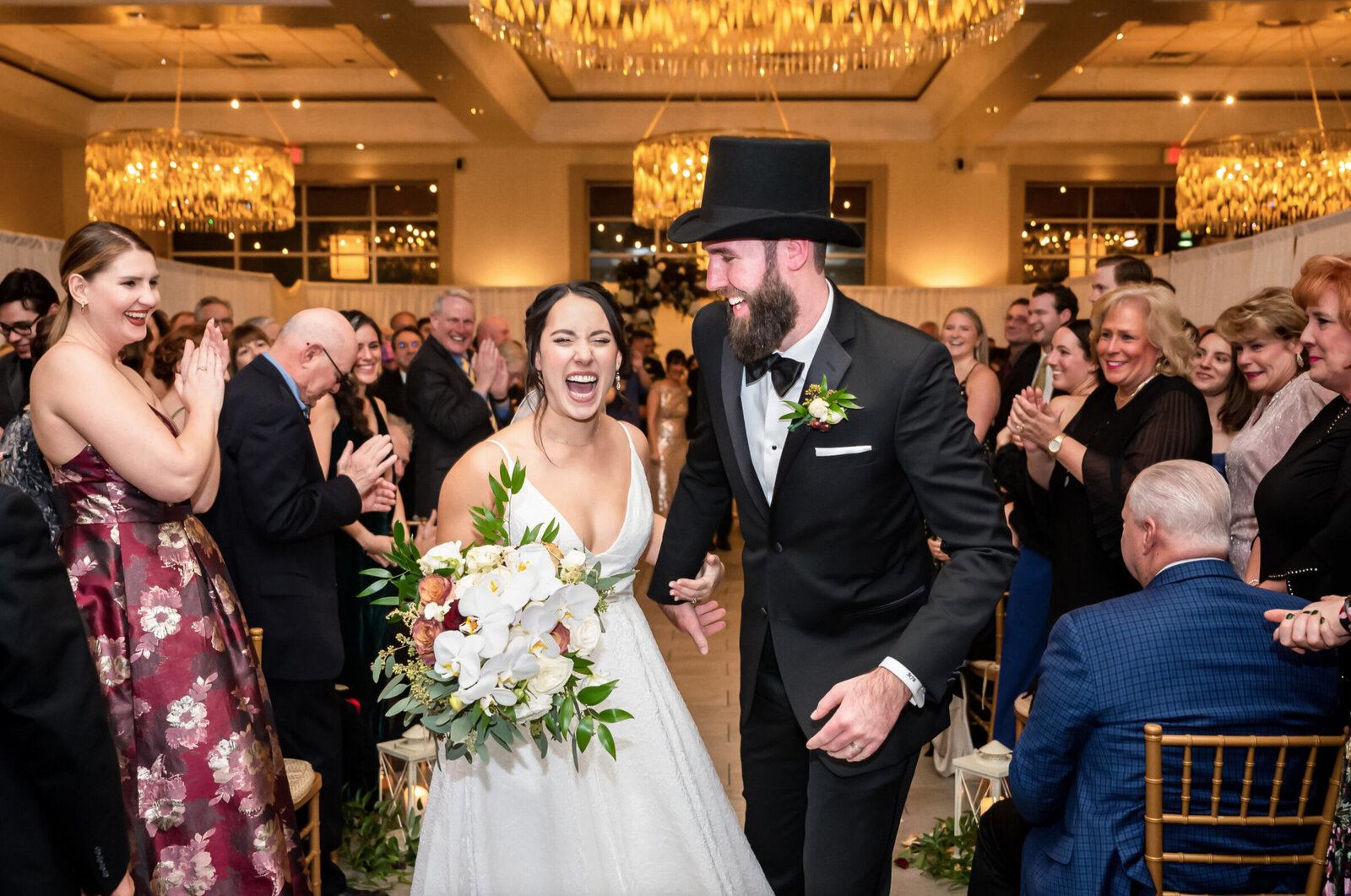 Bride and groom excitingly, leaving their wedding ceremony at the Stonehouse at Sterling Ridge in Warren New Jersey