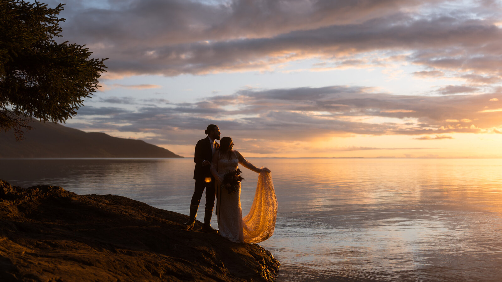 Bride and groom on beach at sunset