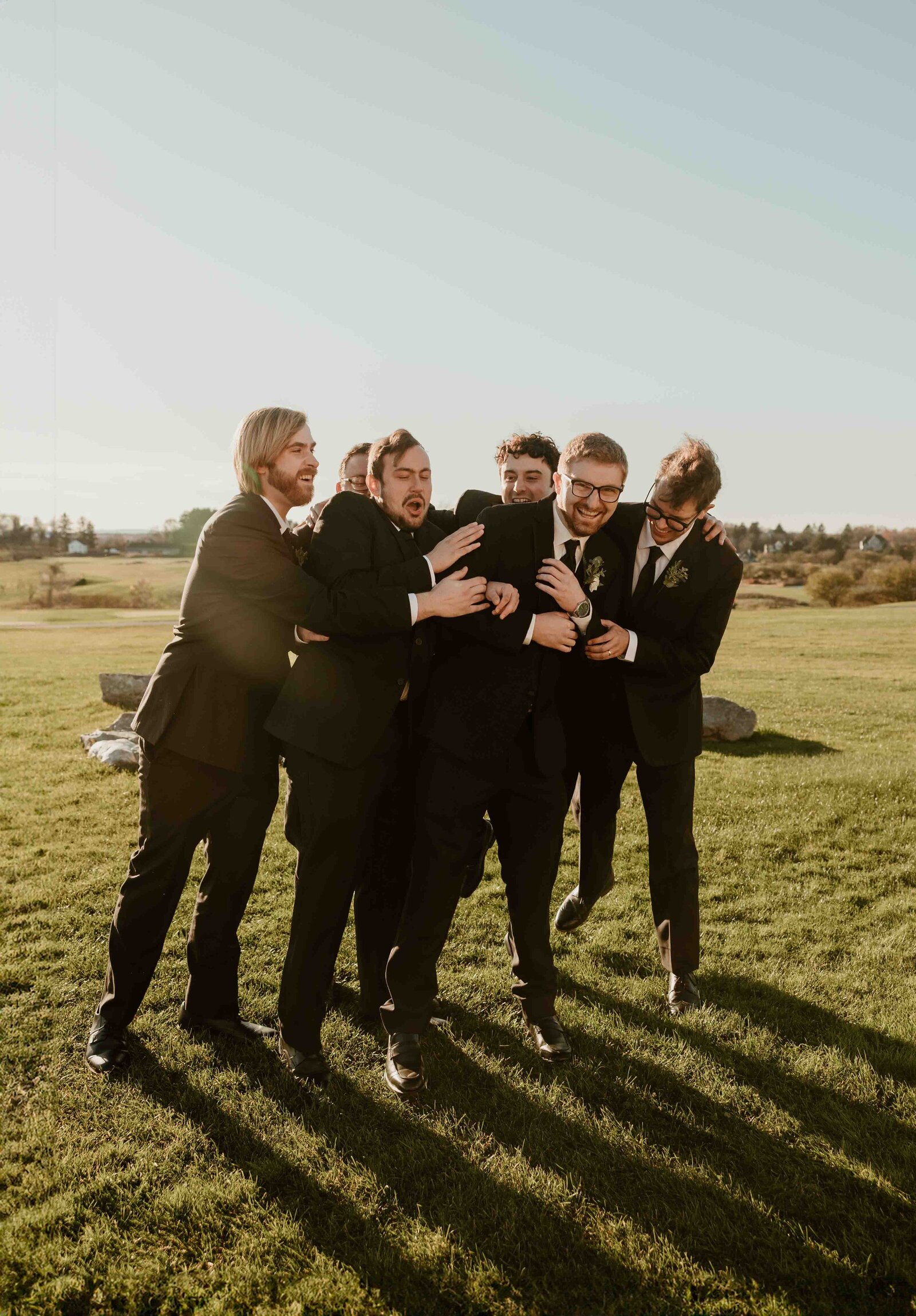 Groomsmen tackling each other.