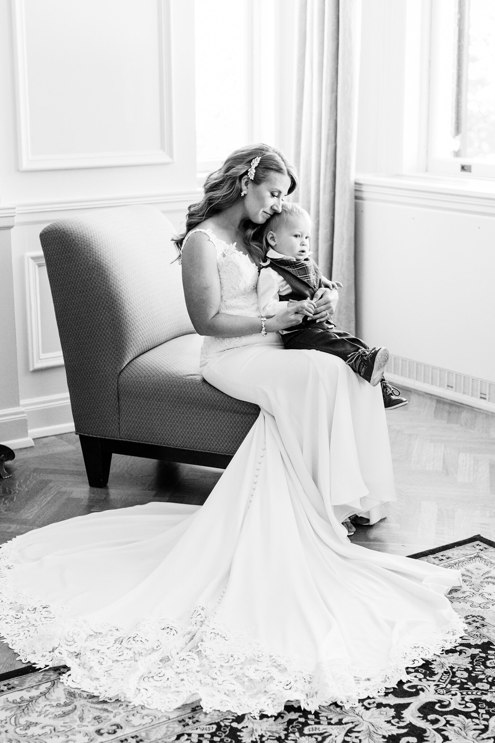 Bride-embraces-her-son-in-her-wedding-dress-before-her-wedding-ceremony