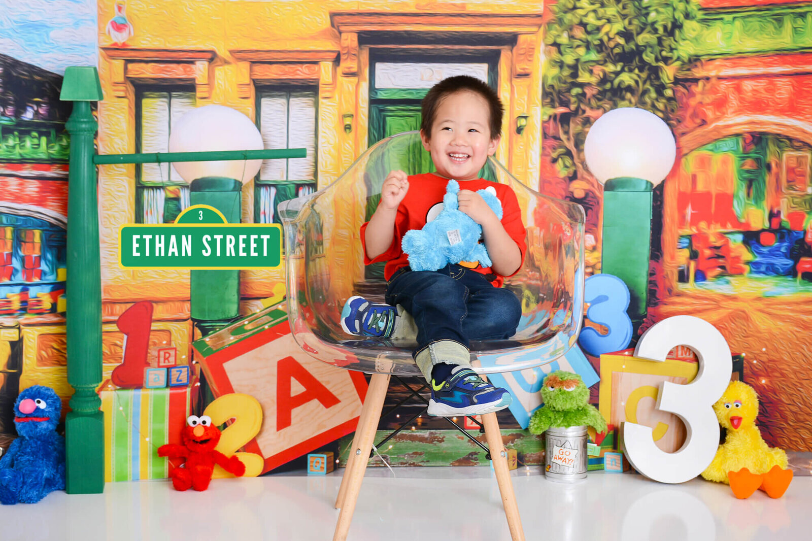 boy smiles at his sesame street themed photoshoot