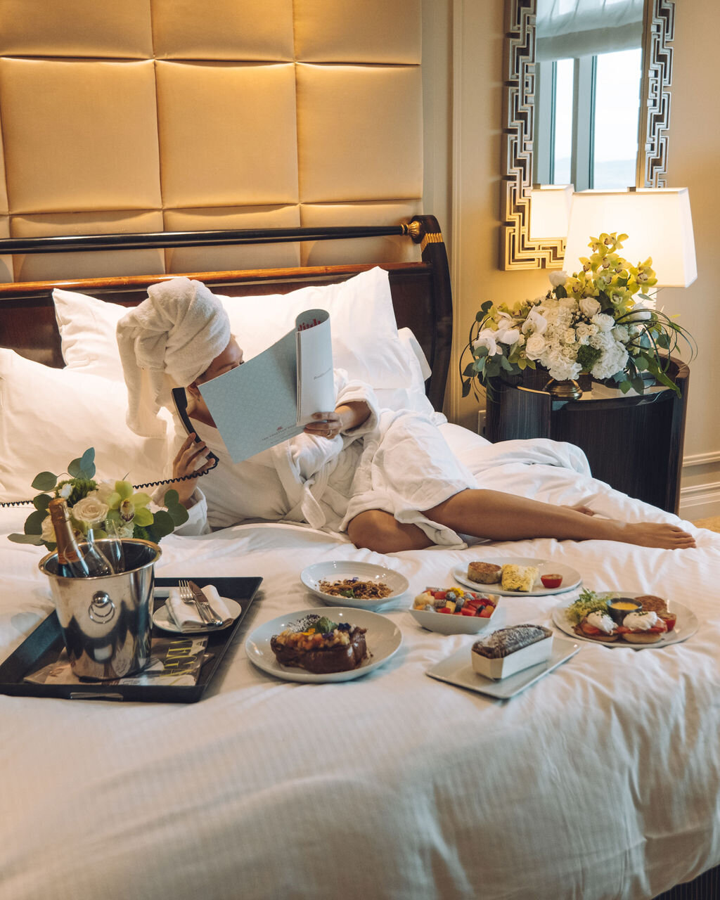 girl wearing towel having breakfast in bed at The Venetian Hotel in Las Vegas