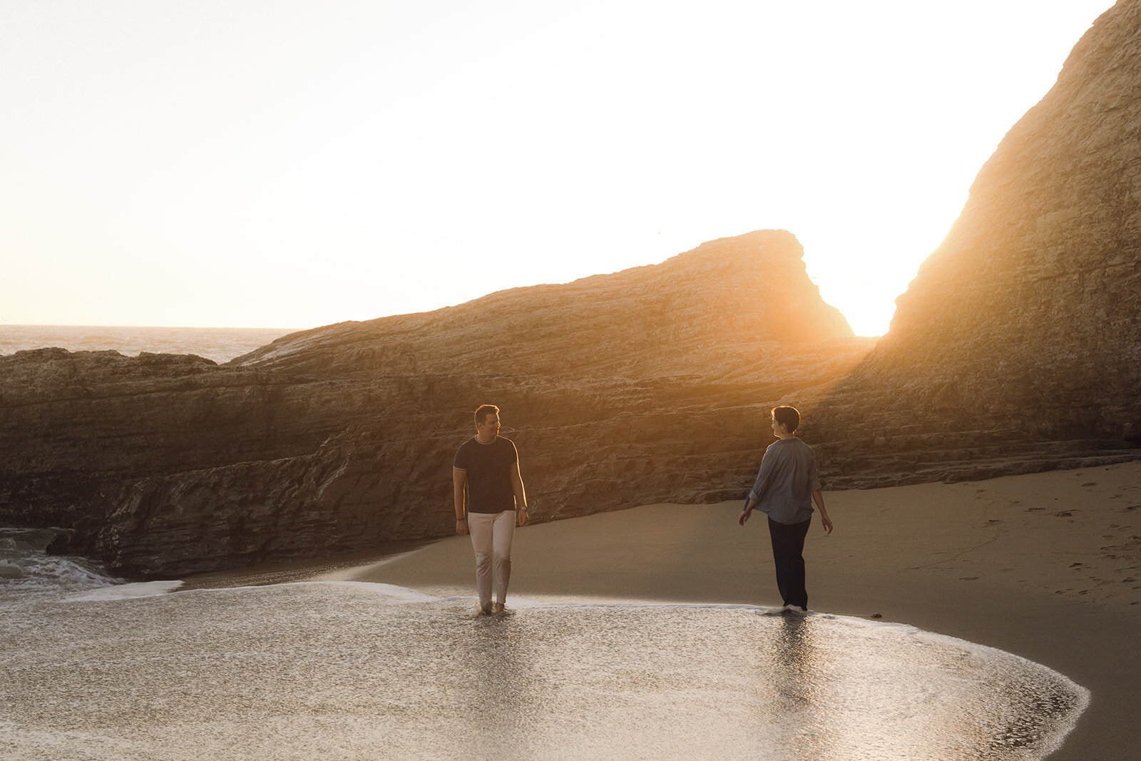 Cinematic engagement photography session on a California beach, capturing intimate moments between a couple during sunset, perfect for luxury wedding inspiration.