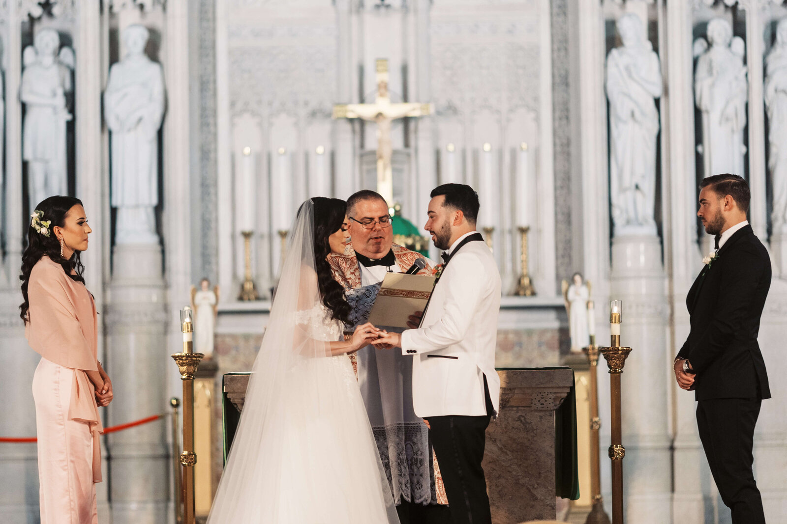 Bride and groom exchange rings on their wedding day in a NJ church.
