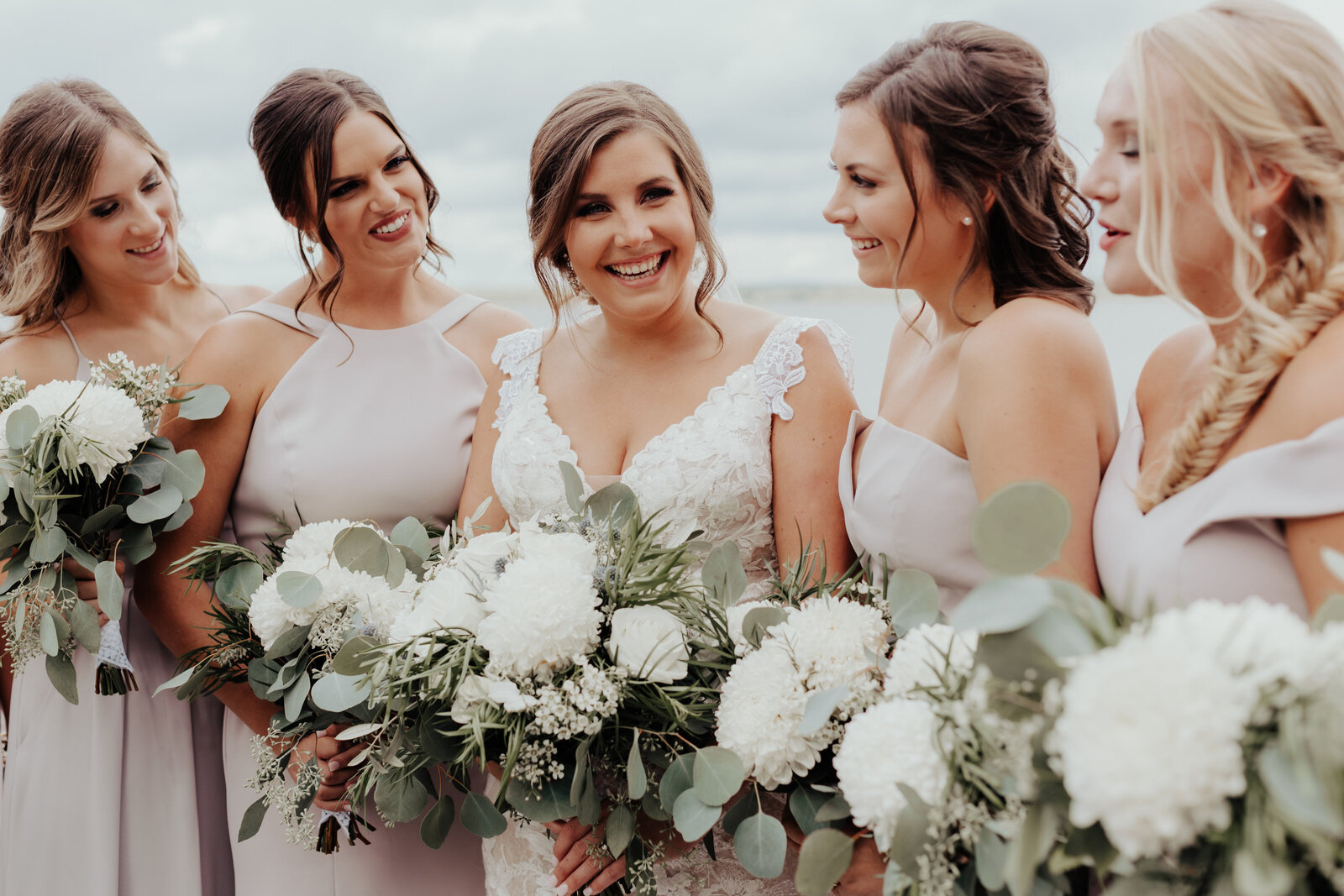 Bride laughing with bridesmaids