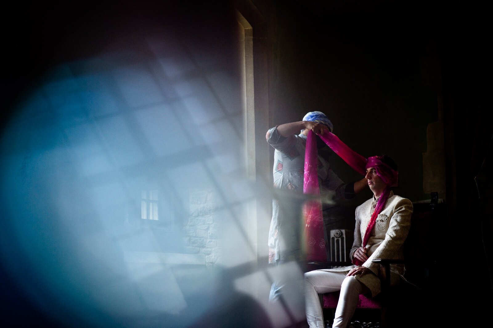 hindu groom during a ceremony getting his headdress applied