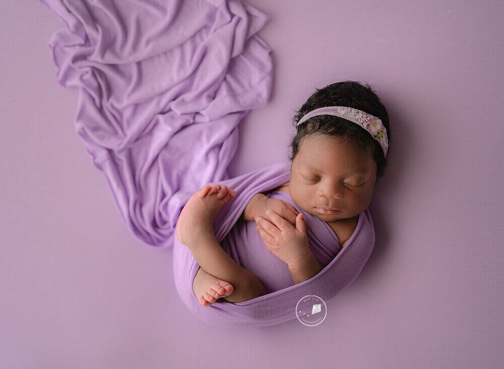 baby girl in purple wrap
