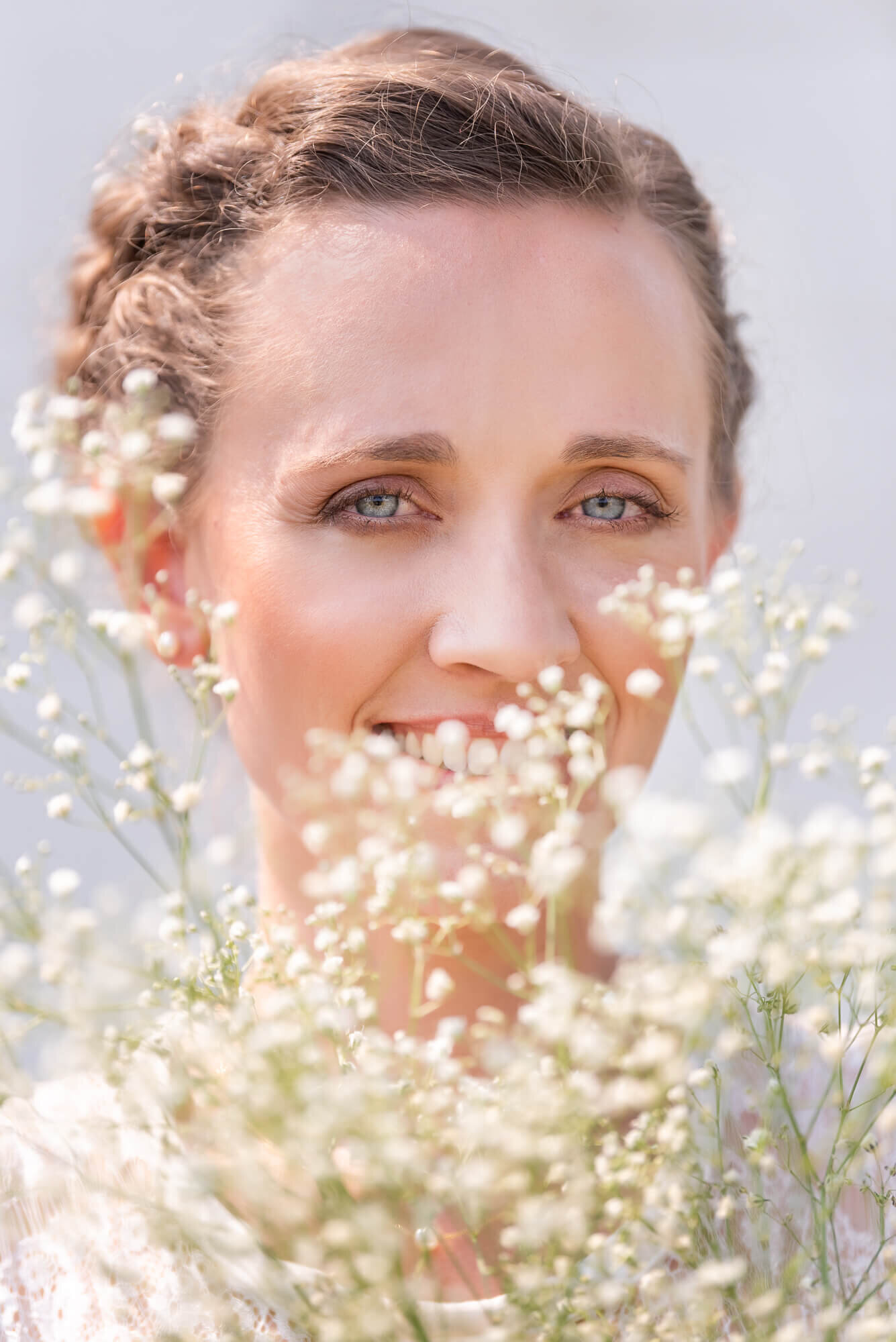 Bridal Portrait closeup behind baby's breath flowers