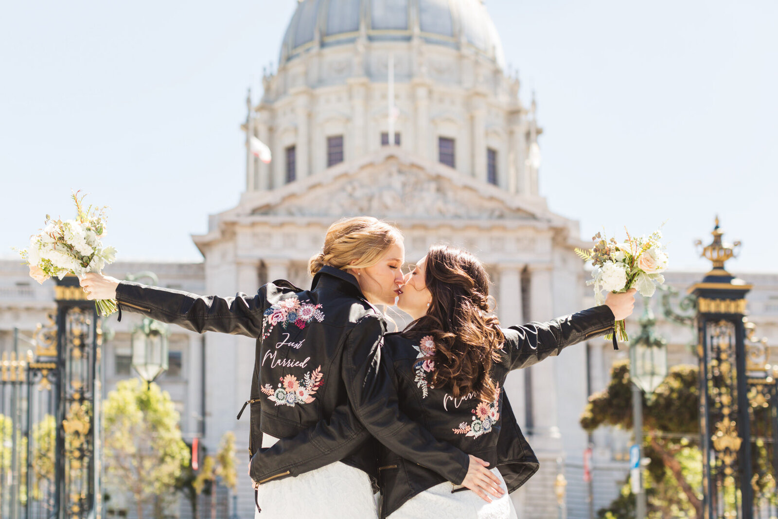 LGBTQ+ wedding with two brides with City Hall in the background