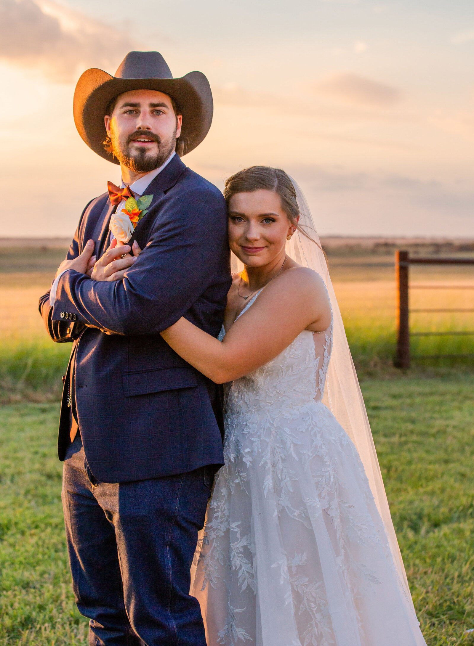 bride hugging groom at sunset
