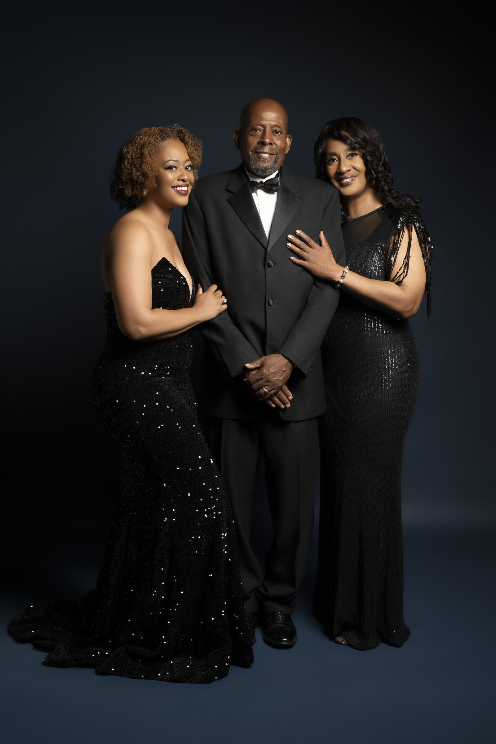 Sophistication and elegance of the black family as parents pose with adult children. 