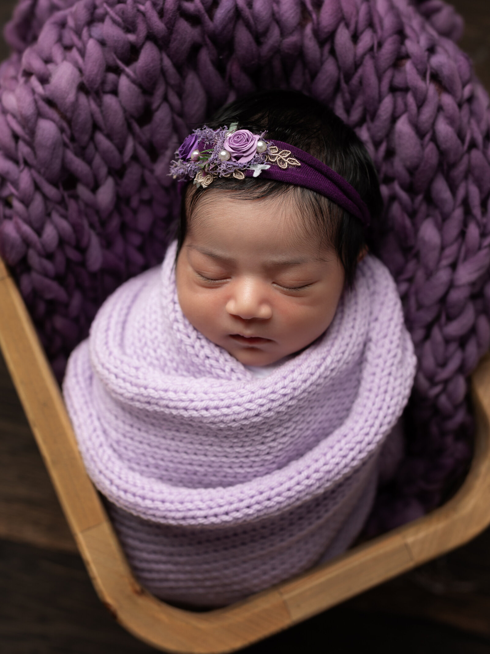 newborn baby girl wrapped in lavender color for newborn studio portraits cleveland newborn photographer