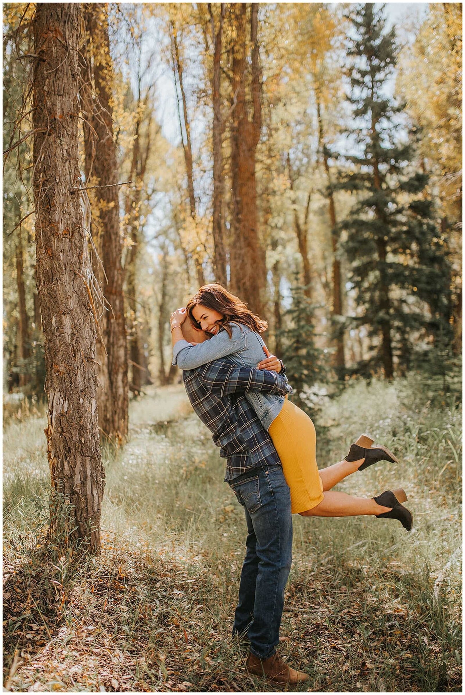 Sacramento Wedding Photographer captures man lifting woman in yellow dress during outdoor engagements