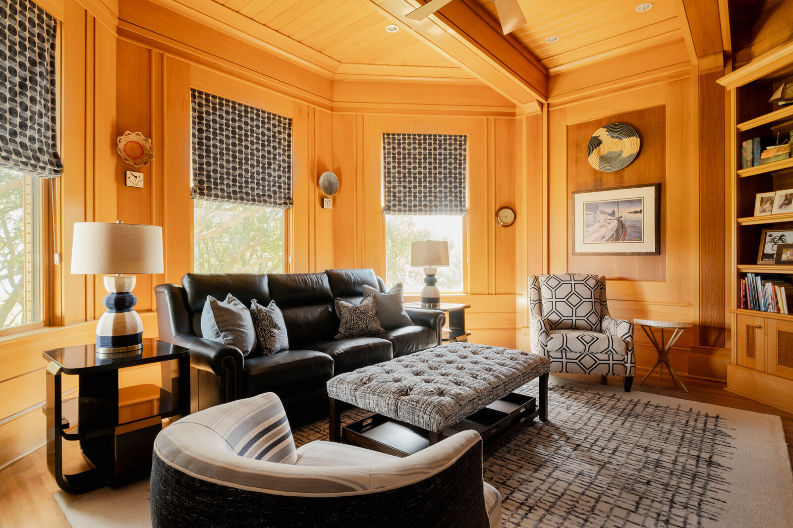 Living room remodel of a coastal home in Wilmington, NC, featuring serene, watery colors, updated flooring, and large windows framing stunning Intracoastal Waterway views."