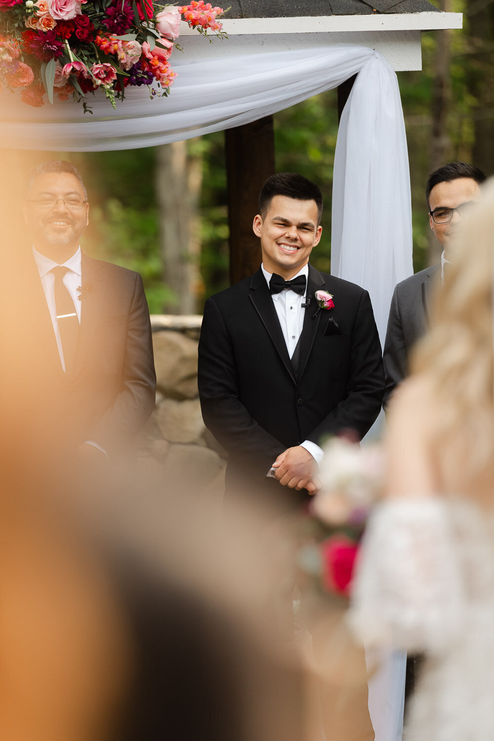 groom watch as bride comes down aisle