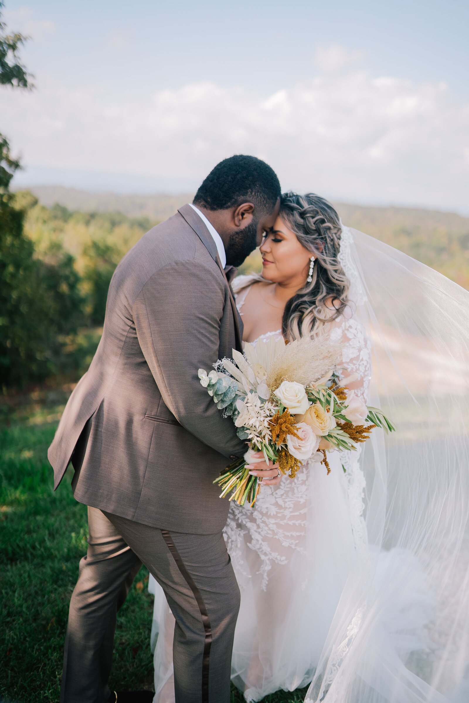 Sacramento Wedding Photographer captures groom hugging bride after outdoor wedding