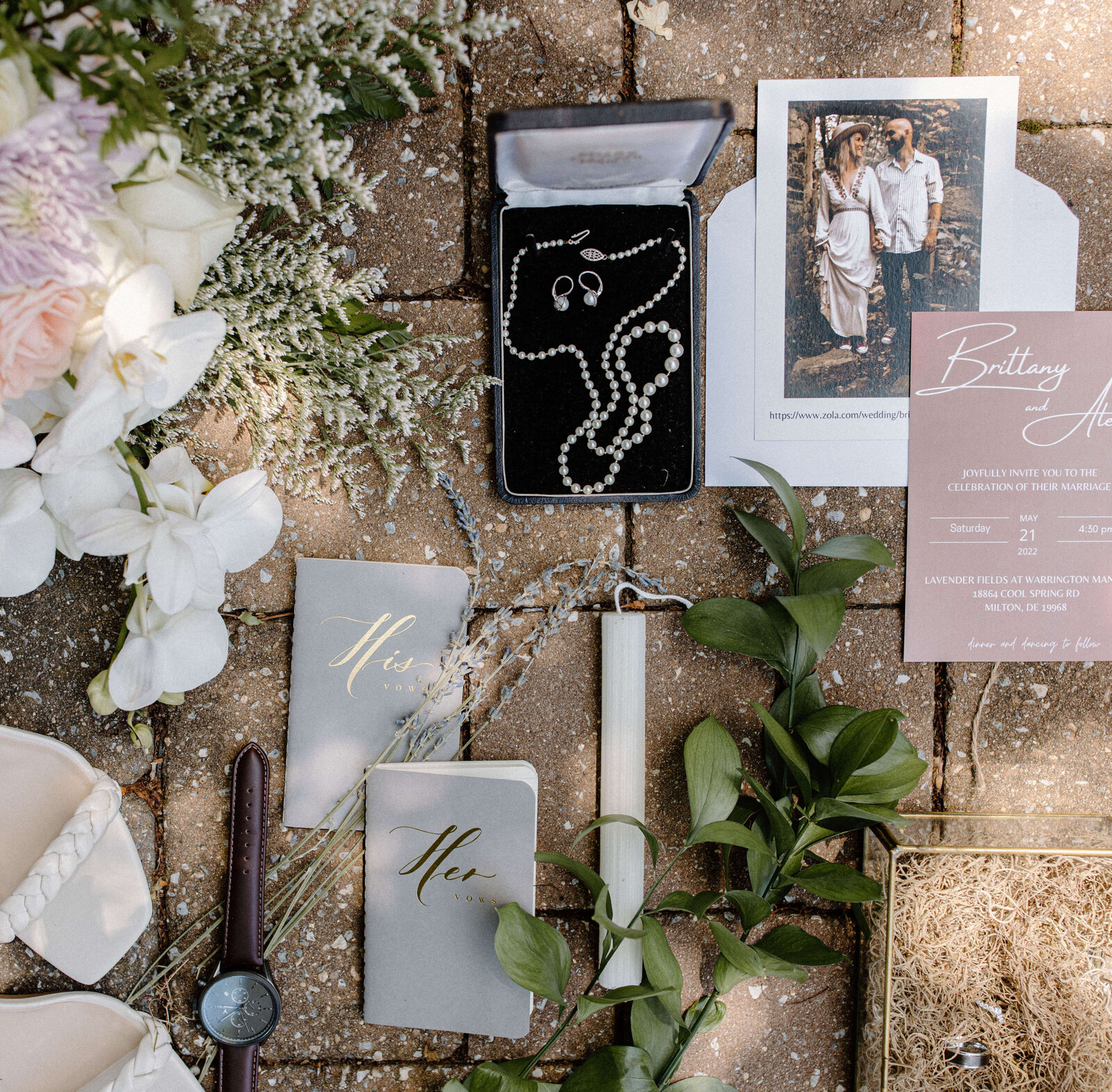beautiful wedding flat lay outdoors with greenery and jewelry by sabrina leigh photography