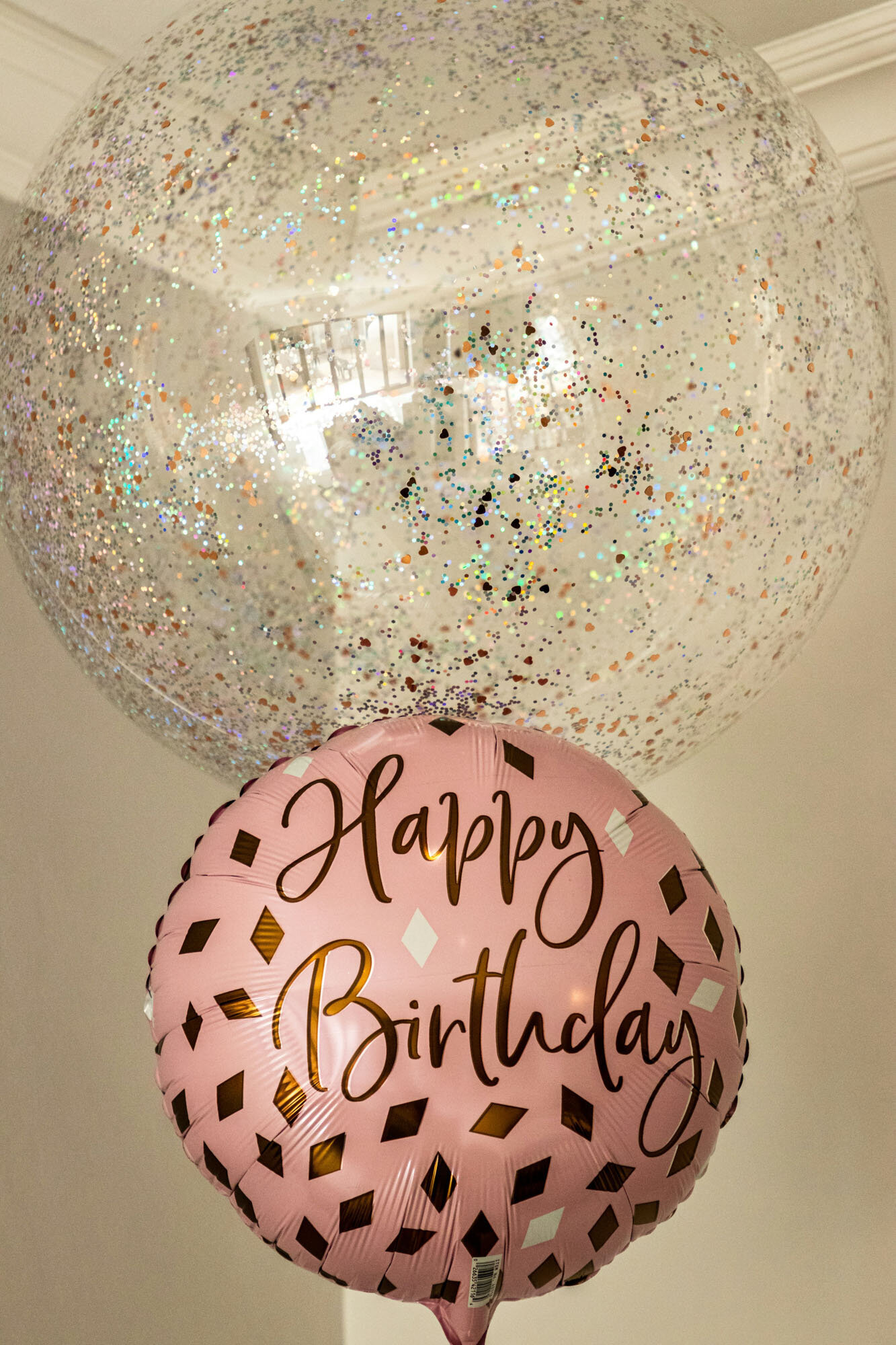 Pink balloon with the words happy birthday on it