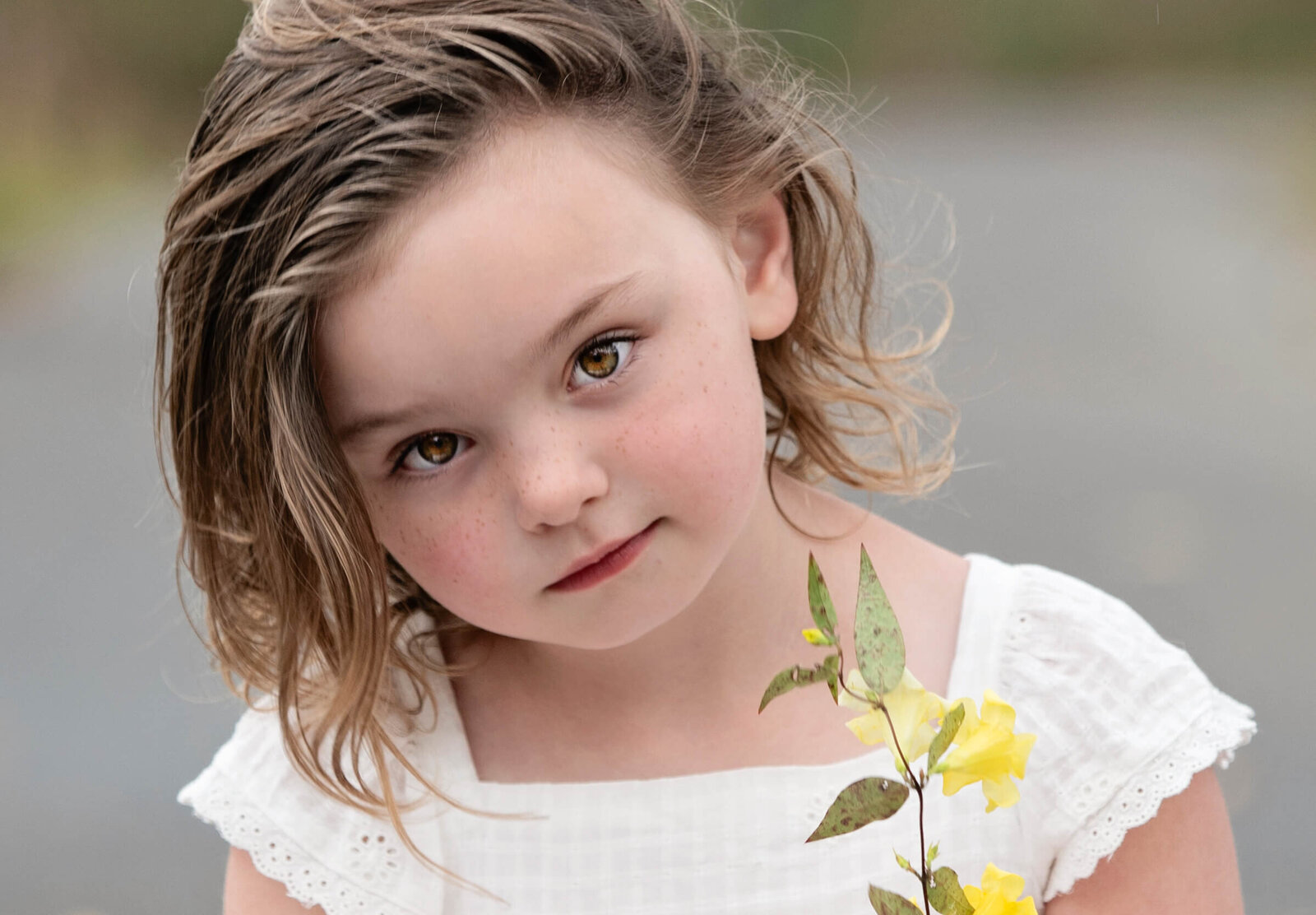 Portrait of a little girl holding a flower in Erie Pa