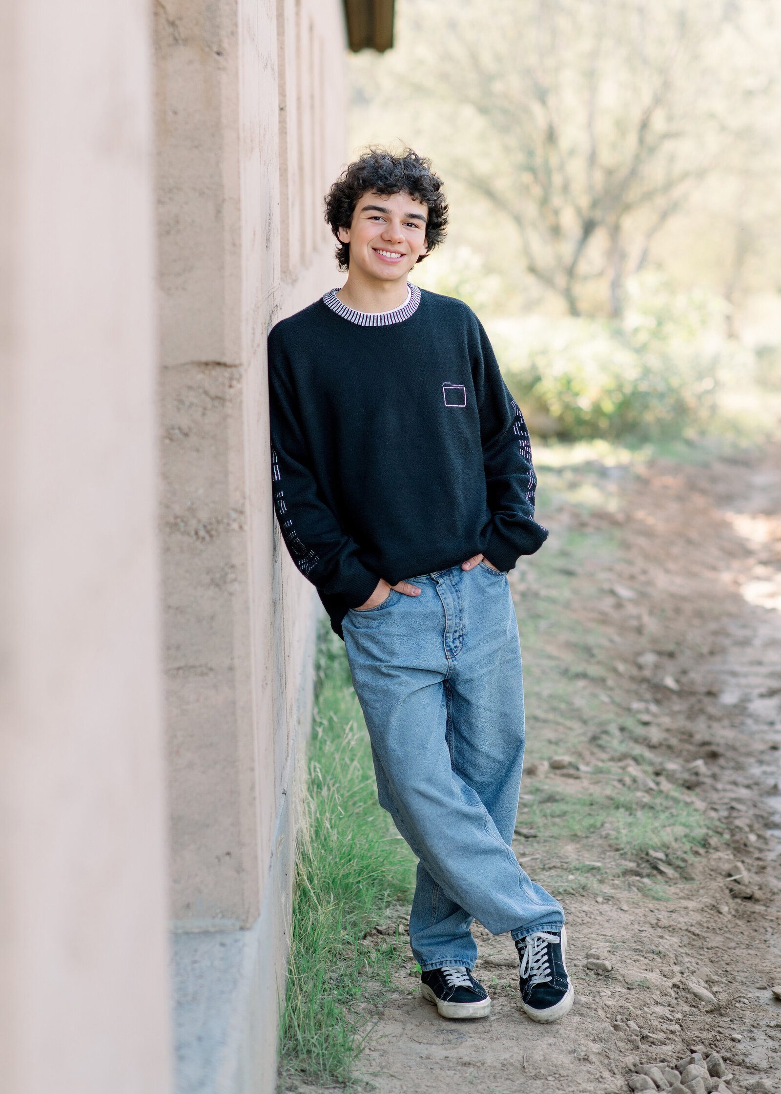 pinnical high senior boy posing for senior photos in the north scottsdale desert