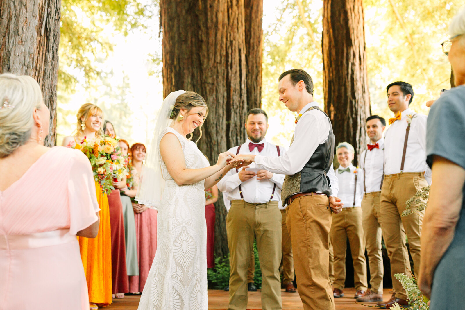 Bride and groom at their colorful wedding ceremony in Santa Cruz, California in the redwood trees.