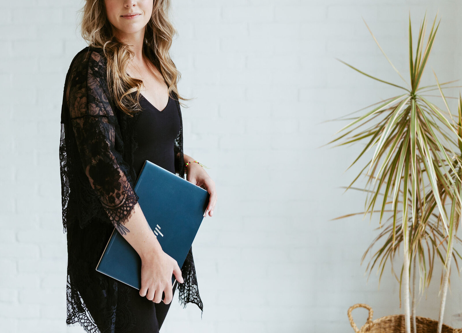 woman standing with laptop