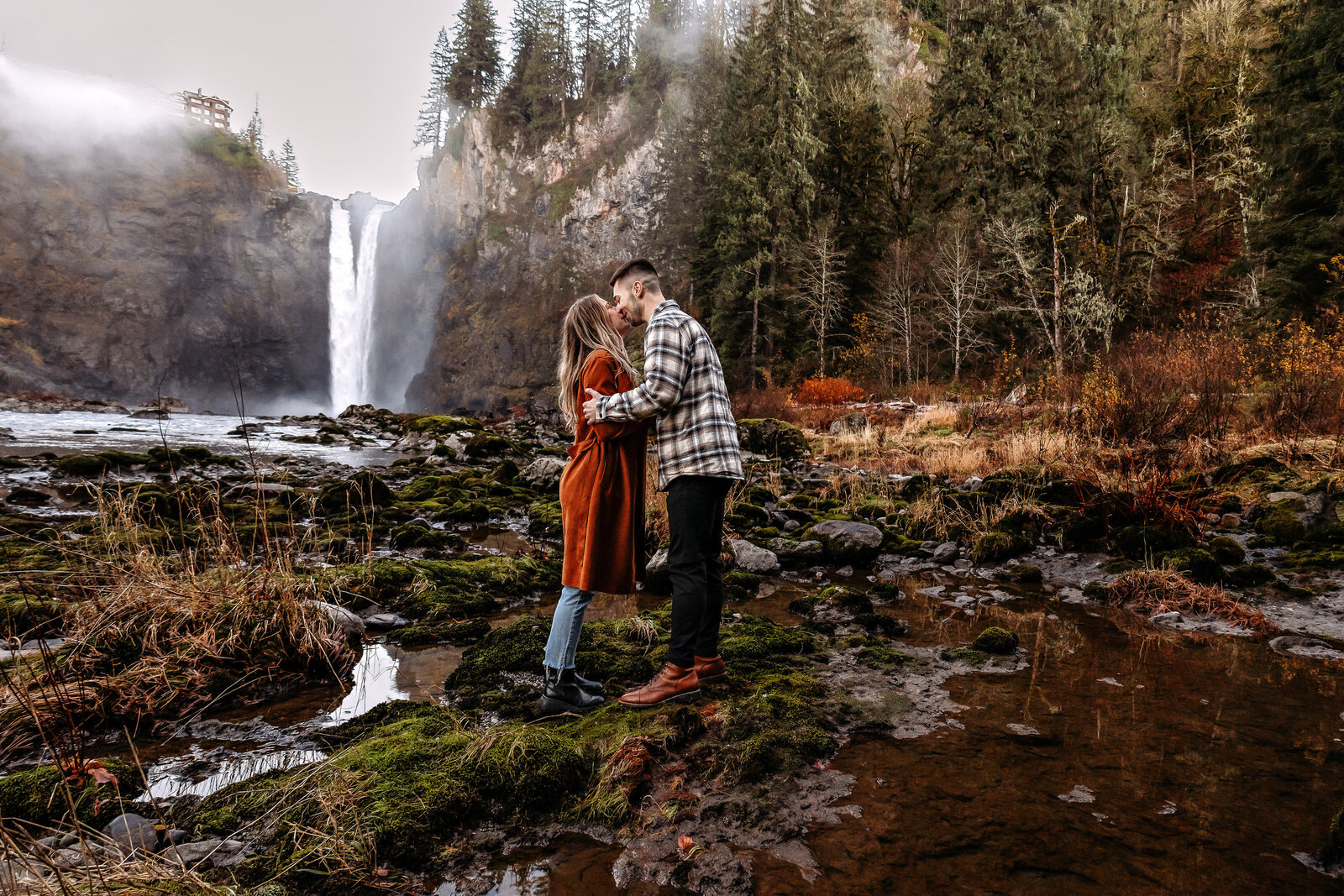 Witness the sheer joy of a couple getting engaged beside the iconic waterfalls of the Pacific Northwest, a symbol of their blossoming future together captured in this heartwarming photo.