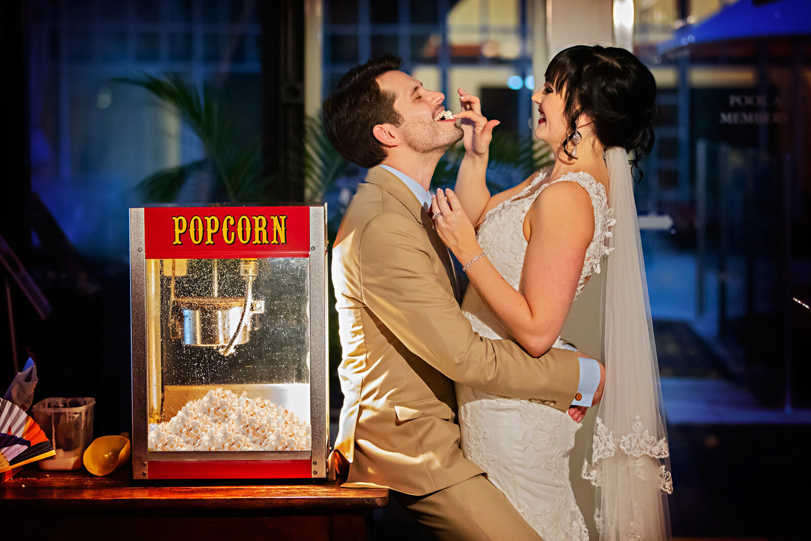 wedding couple feeding each other popcorn at crown plaza in the bar