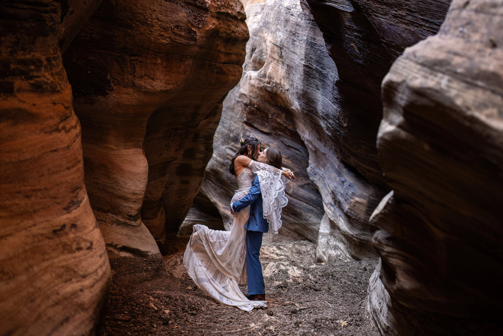 bride and groom kissing in a Zion slot canyon