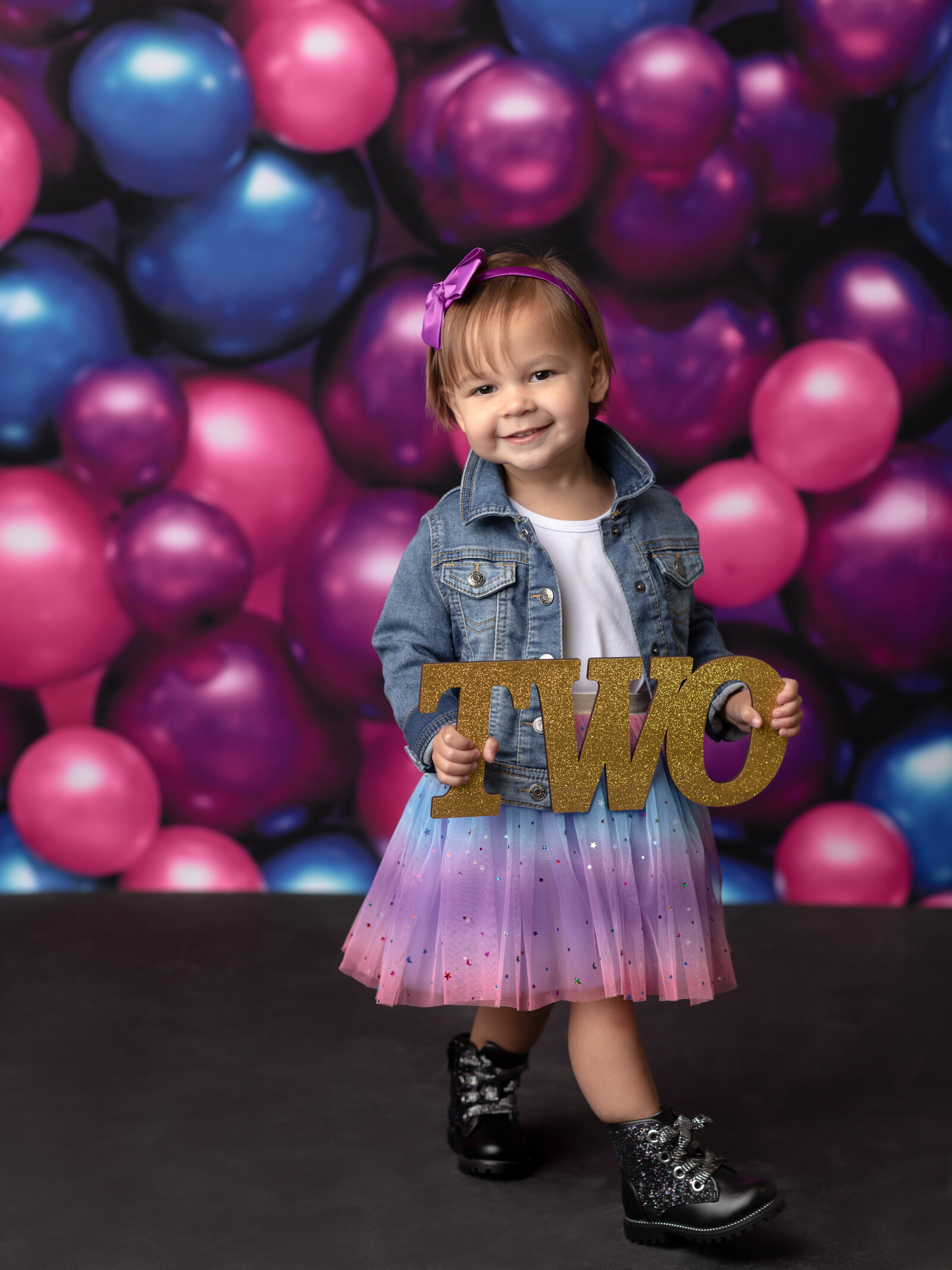 two year old girl posing for studio portraits