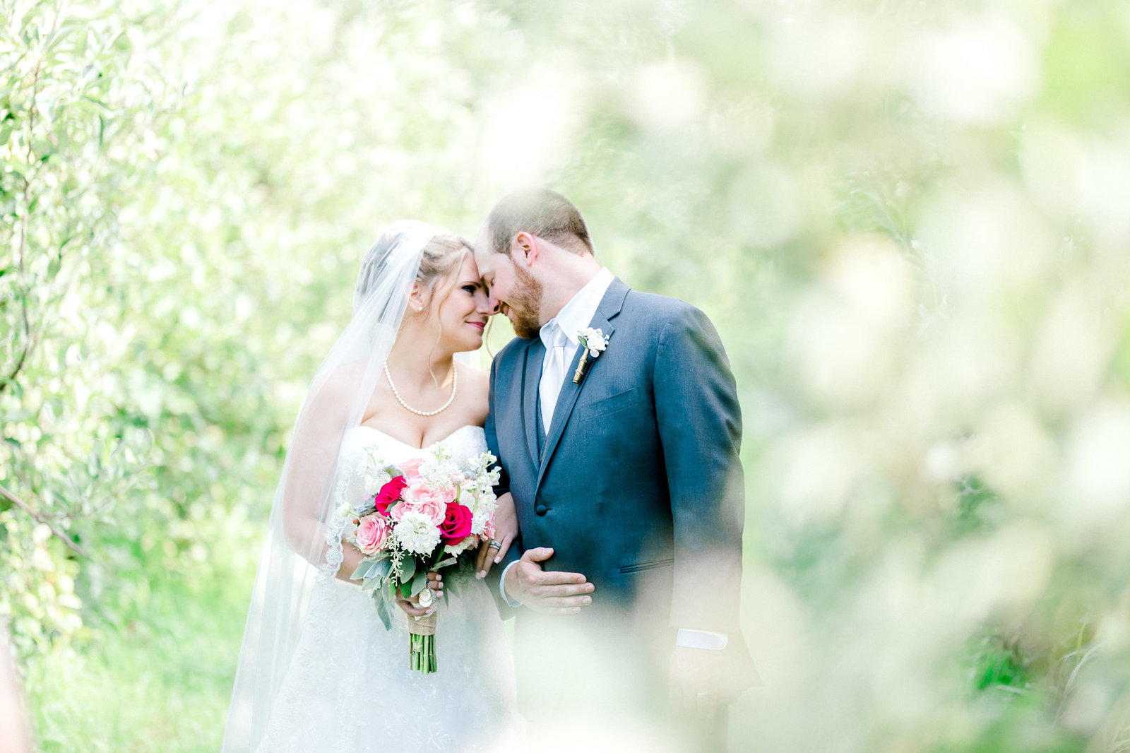 bride and groom in the apple orchard Chicago wedding pictures by Chicago wedding photographer bozena voytko