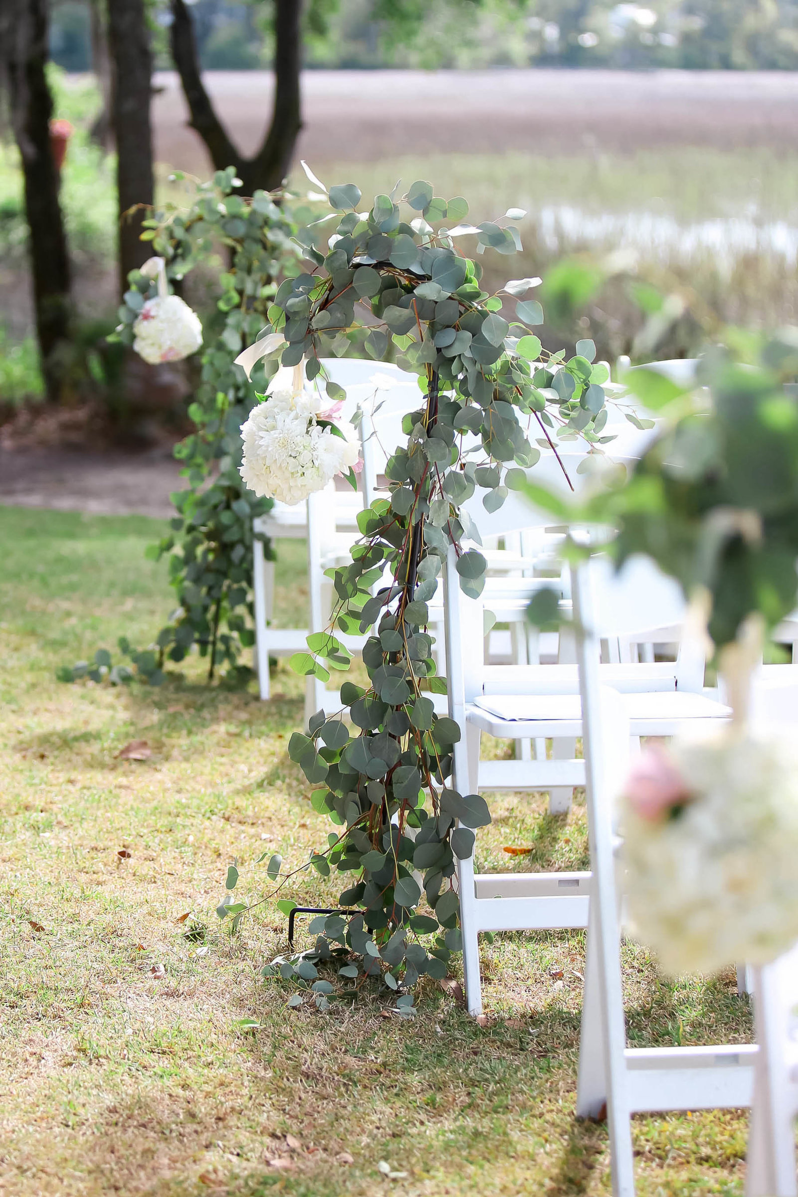 Vine and white flowers adorn the aisle, I'ON Creek Club, Mt Pleasant, South Carolina