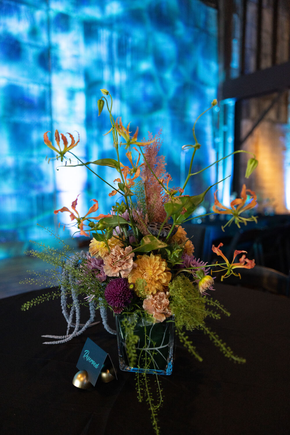 Colorful floral centerpiece with a reserved sign on a table