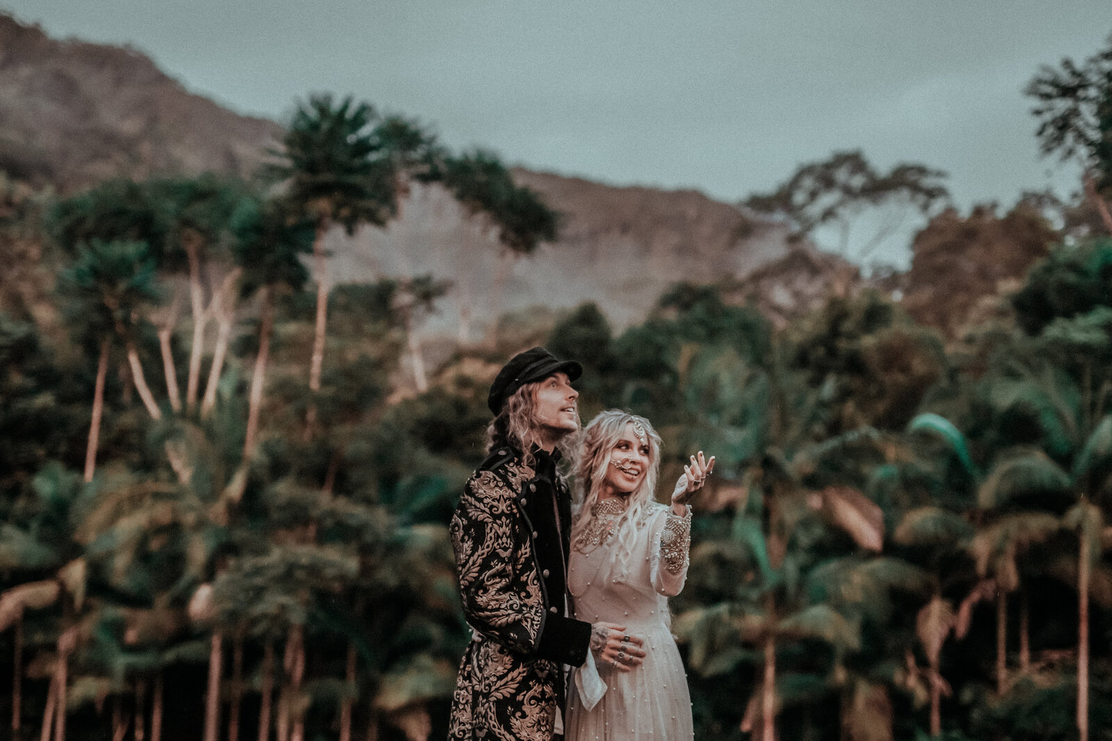 Couple in wedding dress and suit posing outdoors