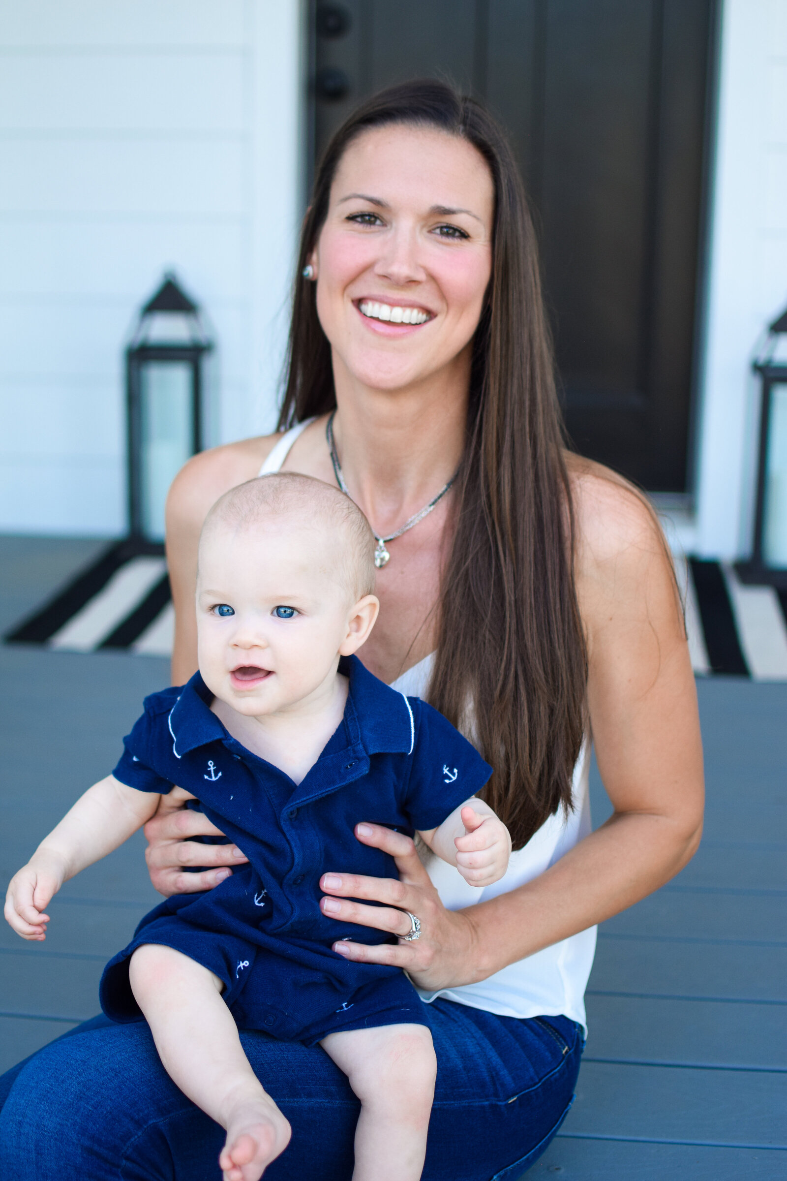 Mom & baby sitting on steps southern front porch project Oakland Park