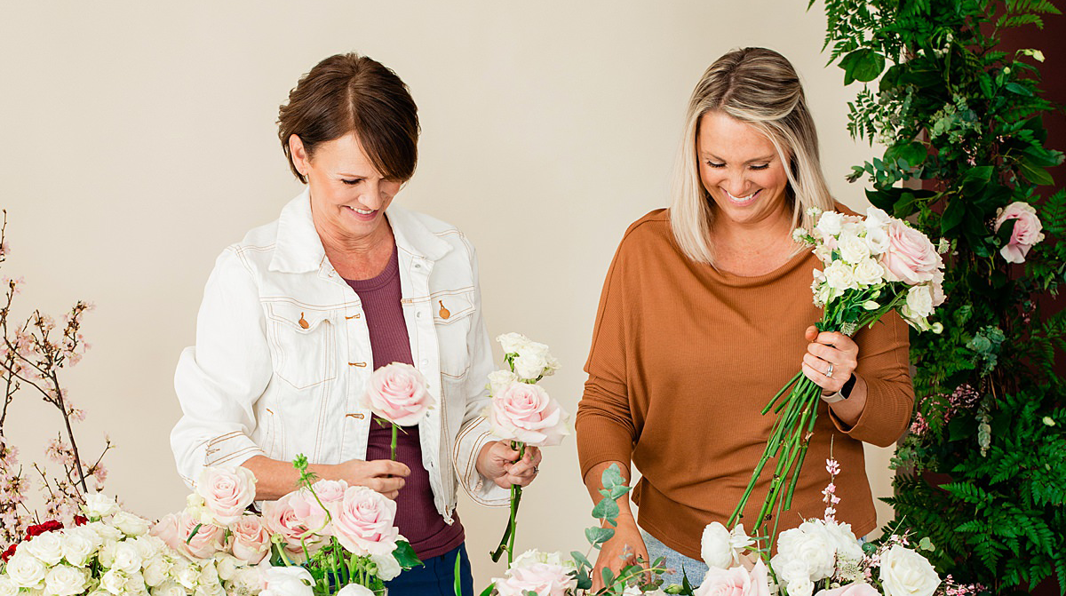 Mother and daughter florist team working together to select flowers