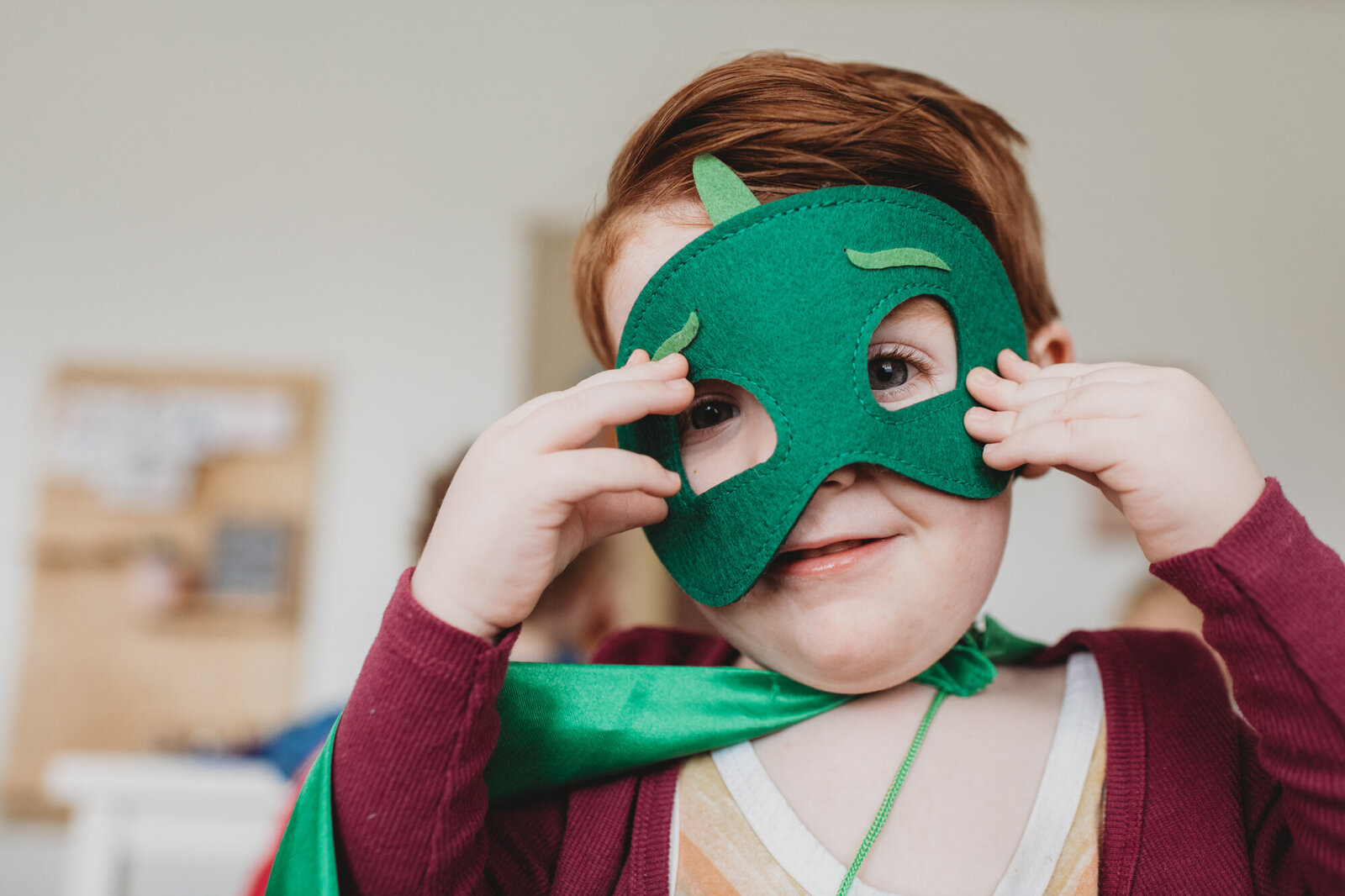 Branding Photographer,  a child is amused as he puts a costume mask over his face