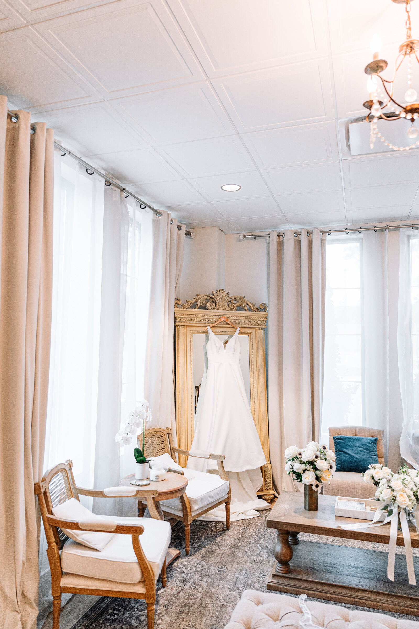 private dressing room with bridal gown on mirror