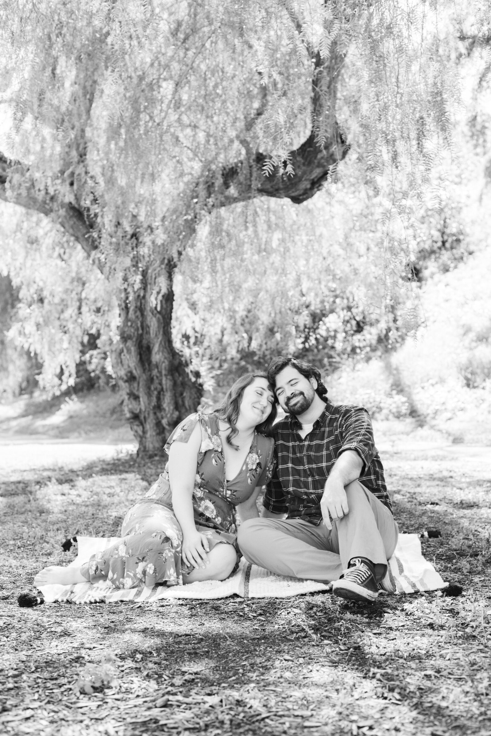 An engaged couple poses for photos in a garden in Los Angeles, Ca.