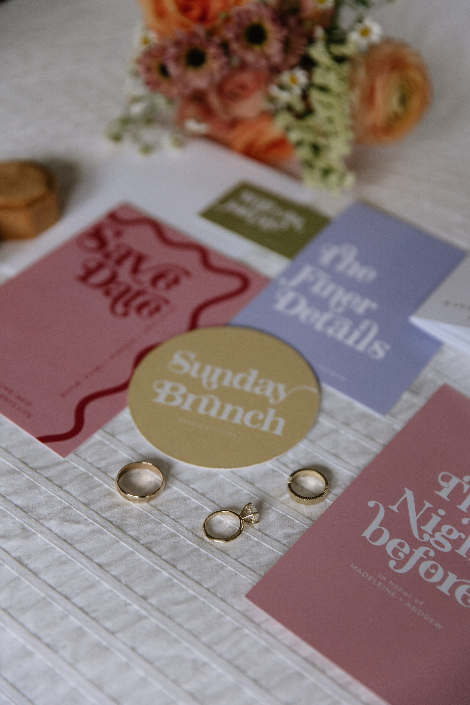 Flatlay of rings, florals, and stationary for elegant Idaho wedding day