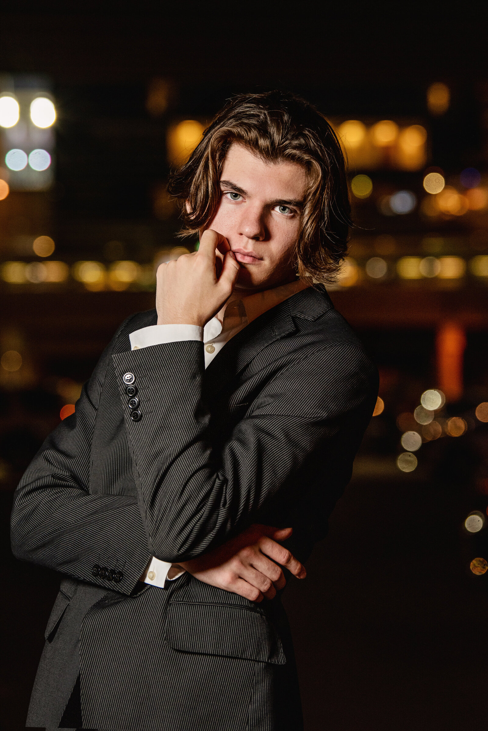 Stillwater Minnesota  high school senior picture of boy in suite in city scene at night