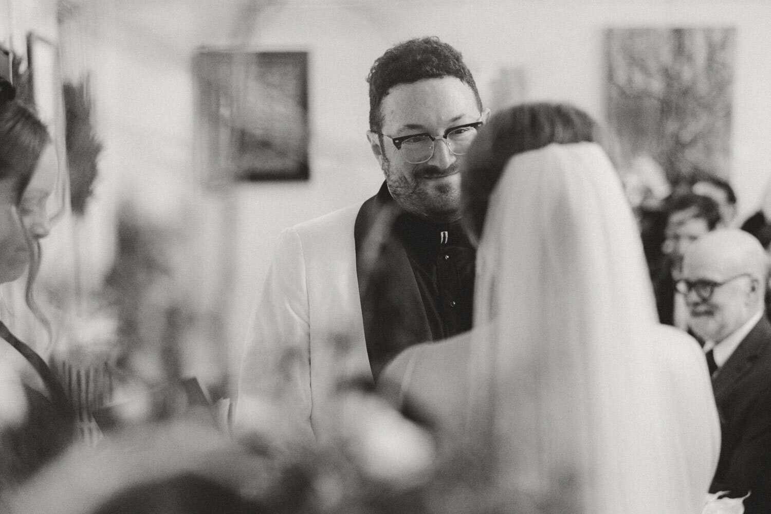 Groom smiling at the bride during their wedding ceremony.