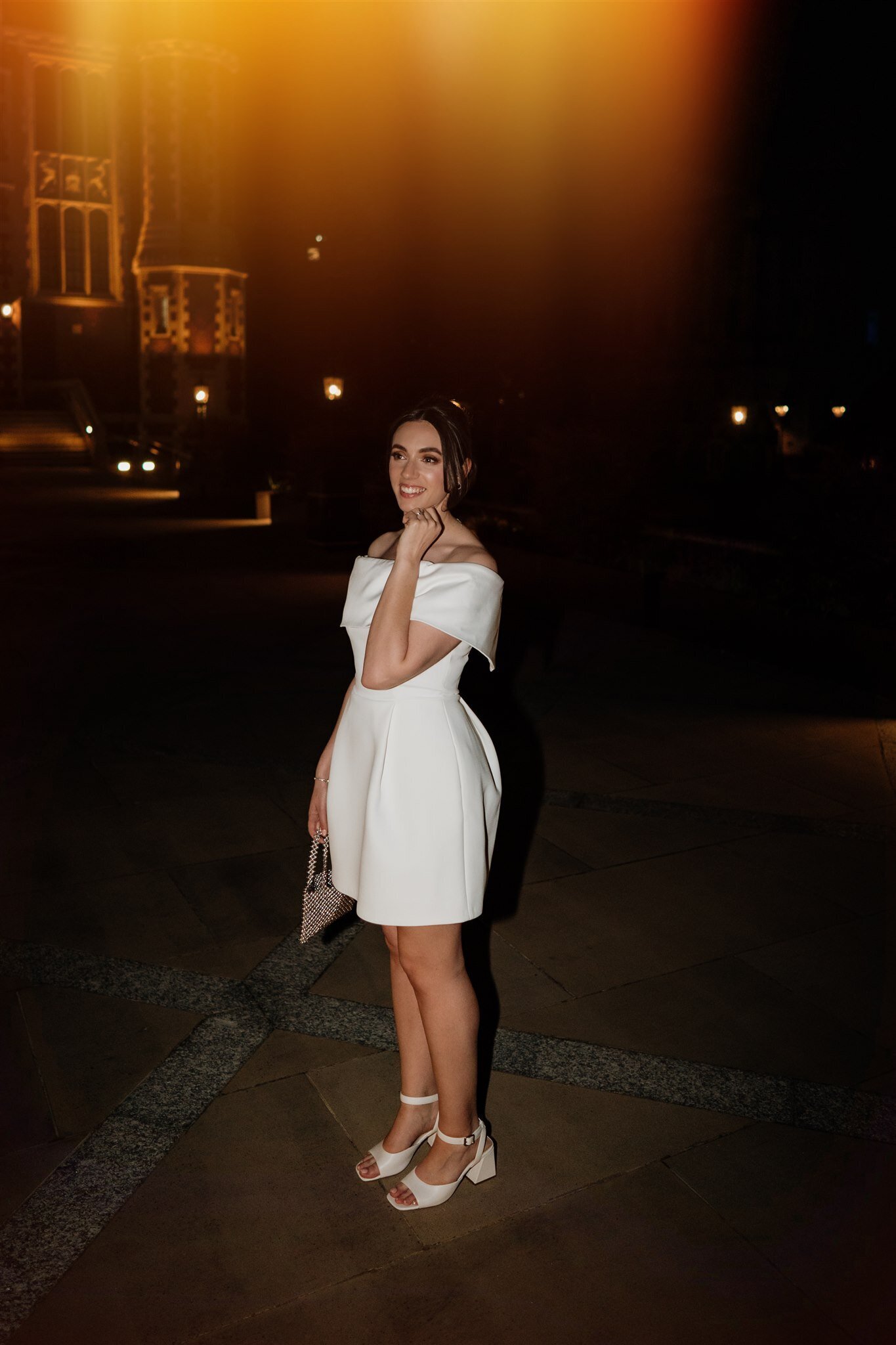 nighttime editorial photo of a bride in a short dress at lincolns inn wedding venue