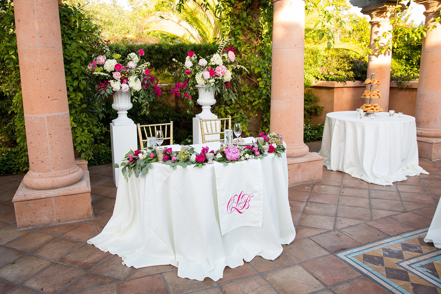 The head table adorned in flowers and a monogram