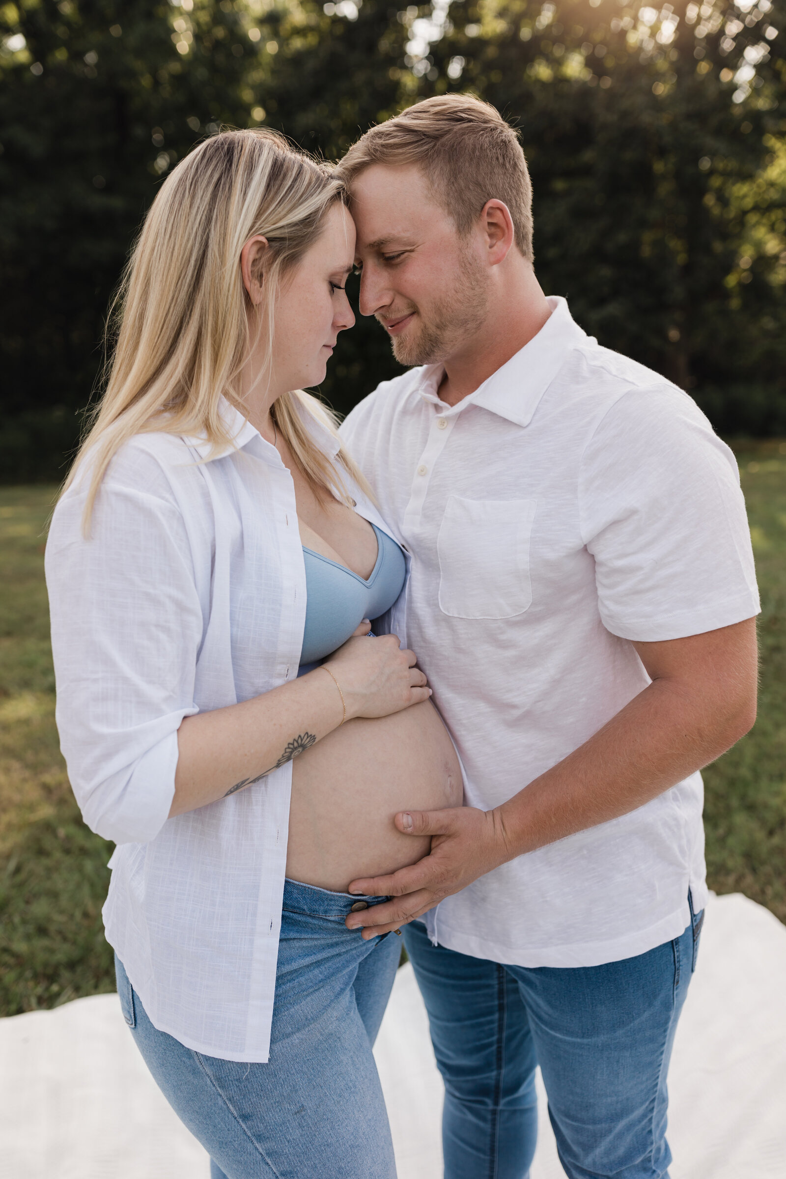 mother and father holding pregnant belly for maternity photoshoot